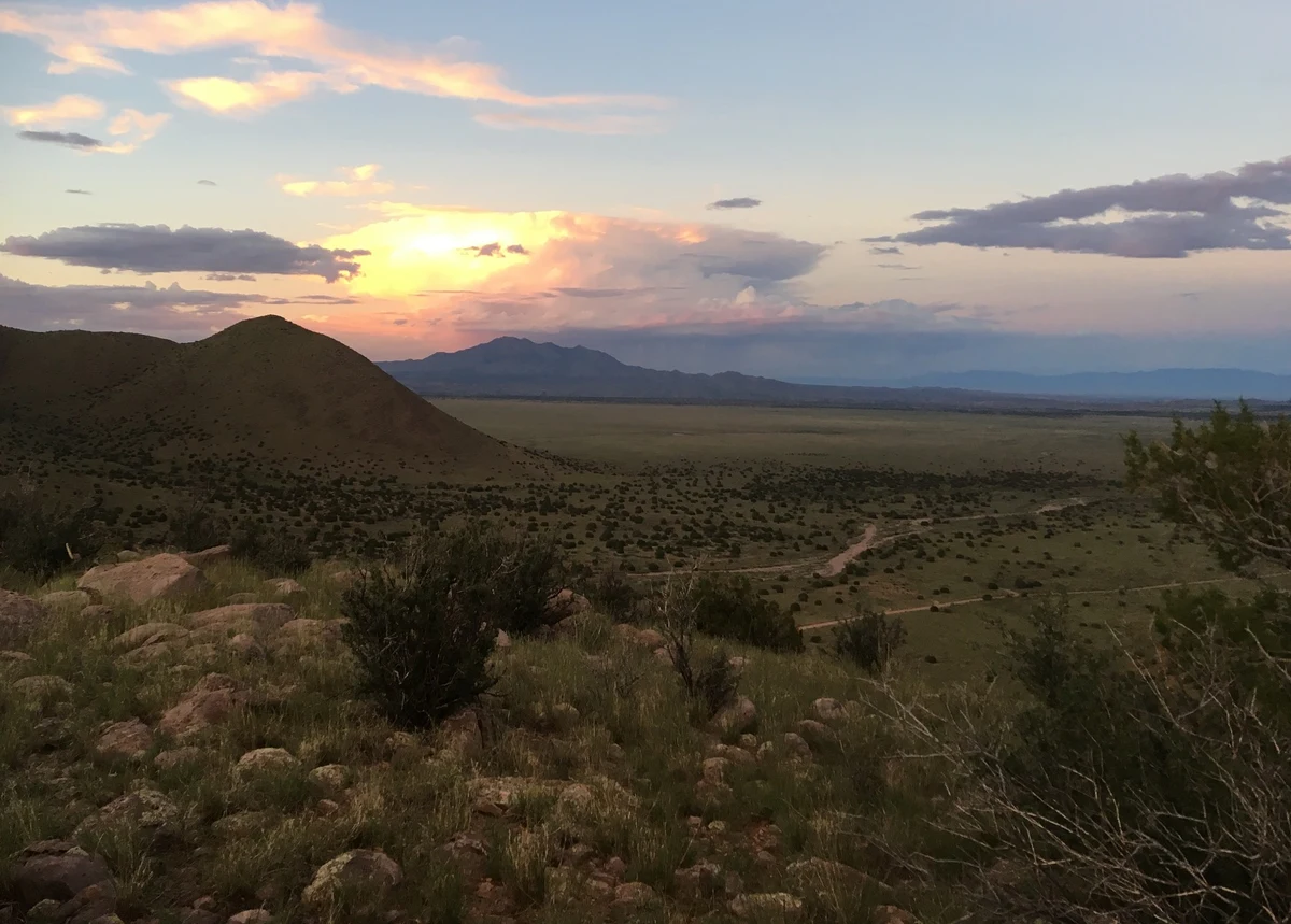 Sunset over an open shrubland landscape
